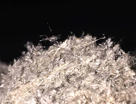 Sample of Mr. Fluffy loose insulation inside a wall of a Canberra home