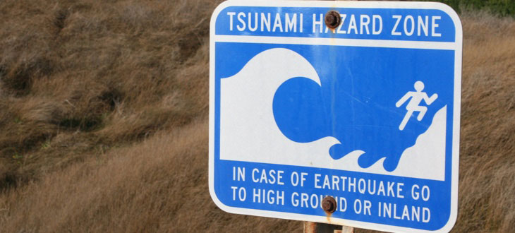 Street sign warning of tsunamis caused by earthquakes