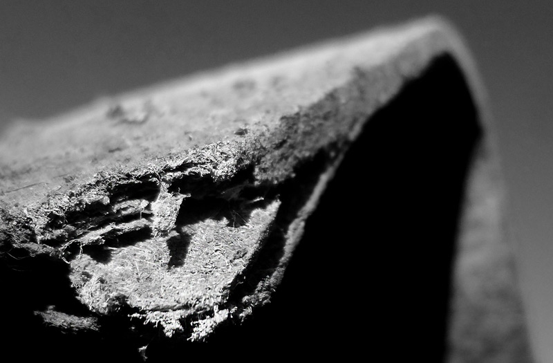 Broken slab of concrete containing nonfriable asbestos