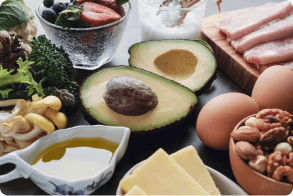 Nutritious foods including avocado, berries, vegetables and eggs