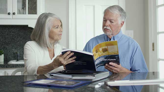 older couple reviewing mesothelioma packet