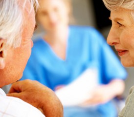 Older couple talking to a caregiver