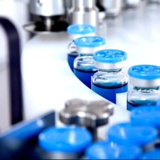 Blue vials on conveyor belt