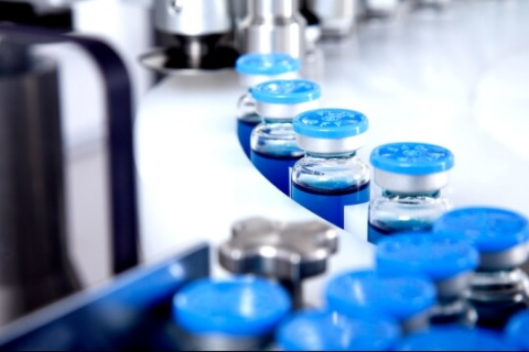 Blue vials on conveyor belt