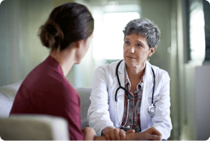 woman discussing her troubles with her doctor