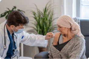 doctor administering vaccine to patient