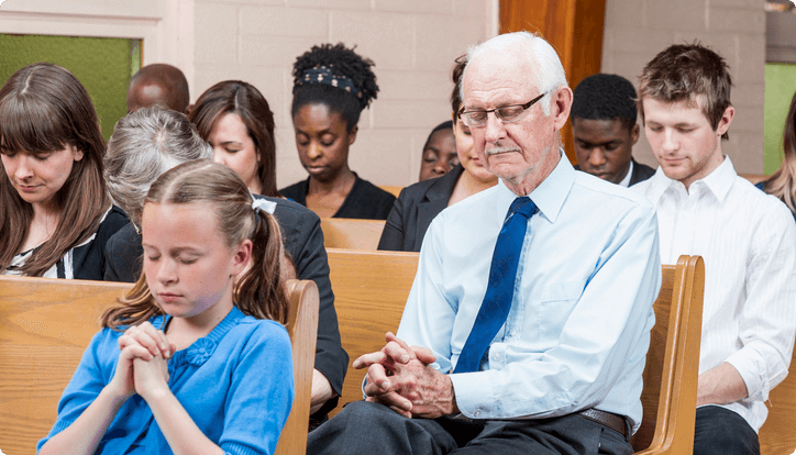 group of people praying at church