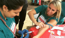 Woman donates blood at a Pacific Heart, Lung & Blood Institute walk