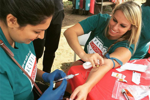 Woman donates blood at a Pacific Heart, Lung & Blood Institute walk