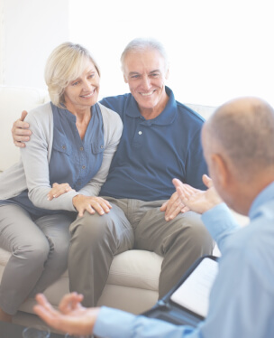 Middle aged couple meeting with a mesothelioma lawyer