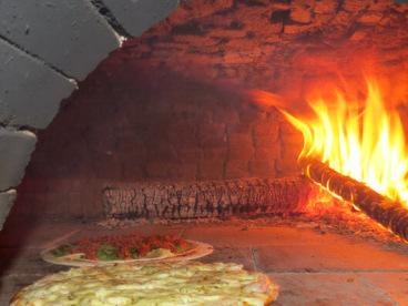 Marguerita pizza baking in the wood oven