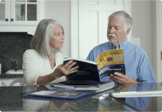 elderly couple read the the Pleural Mesothelioma guide from the Mesothelioma Center together