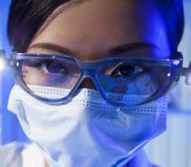 Asian female researcher with glasses and mask over mouth