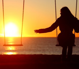 Women on a Swing Enjoying the Sunset Women on a Swing Enjoying the Sunset