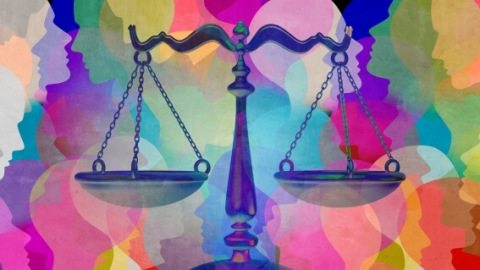 Scales of justice over multicolored faces