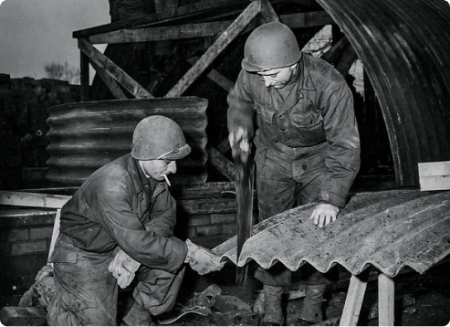 historic image showing servicemen constructing roof with corrugated asbestos sheets