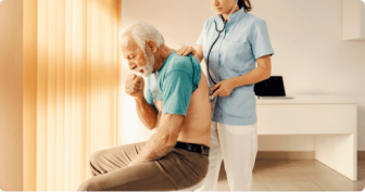 sick man coughing while being examined by doctor