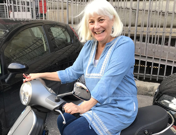 Sissy Hoffman on a scooter in Italy