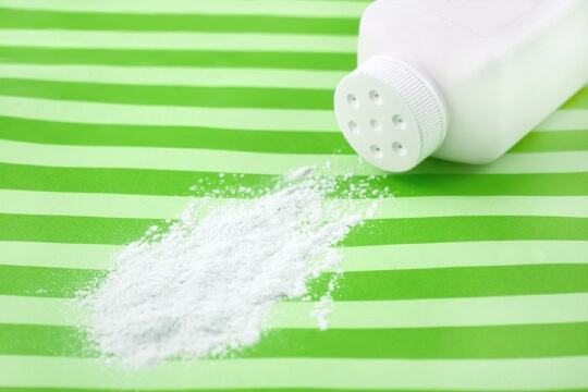 Spilled talc on green striped background