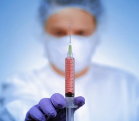Doctor holding a syringe Doctor holding a syringe