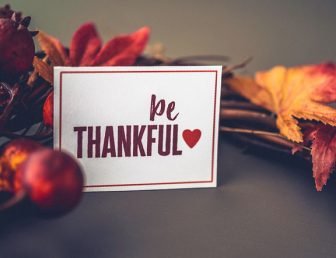Fall leaves background with wreath and message for Thanksgiving
