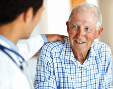 Man speaking with doctor about treatment