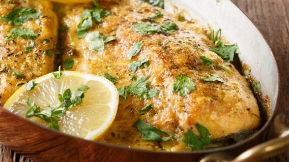 Baked trout with lemon in a pan