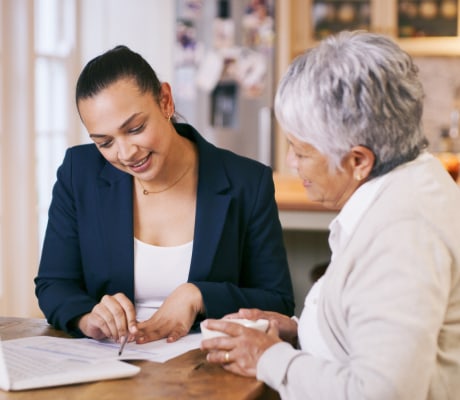 Lawyer with a client in their home looking at documents