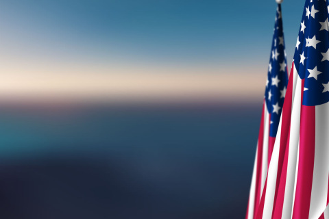 American flag with the sky in the background.