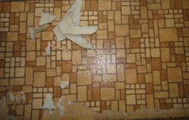 Orange and brown chipped vinyl flooring