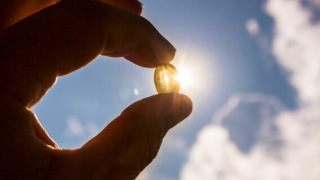 Vitamin D capsule held up to the sun