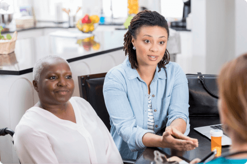 young woman attending doctors appointment with her elderly mother