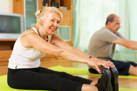 Older couple exercising at home