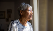 Older woman staring out the window