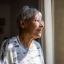 Older woman staring out the window