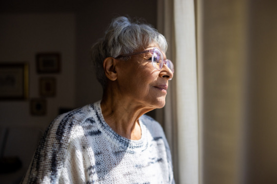 Older woman staring out the window