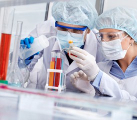 Researchers examining vials Researchers examining vials