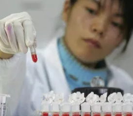 Researcher with samples in vials Researcher with samples in vials