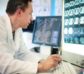 Male doctor looking at X-ray scans Male doctor looking at X-ray scans