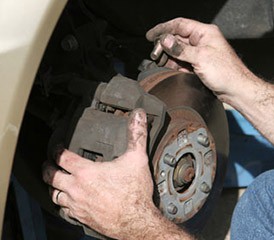 Man adjusting brake pads Man adjusting brake pads