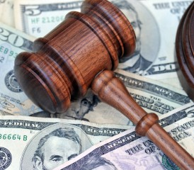 Wooden gavel on money