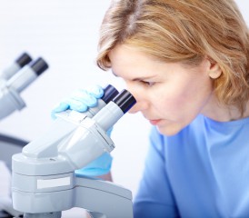 Female researcher with a microscope Female researcher with a microscope