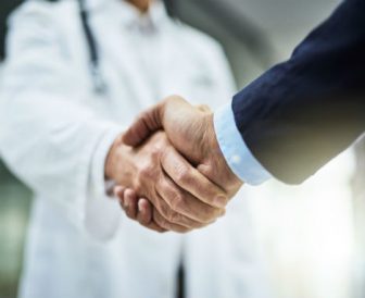 Doctor shaking the hand of a businessman