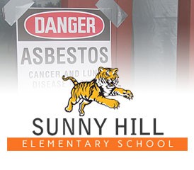 Sunny Hill Elementary mascot with asbestos sign Sunny Hill Elementary mascot with asbestos sign