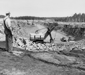 Worker overlooking pit Worker overlooking pit