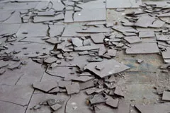 Broken vinyl floor tiles