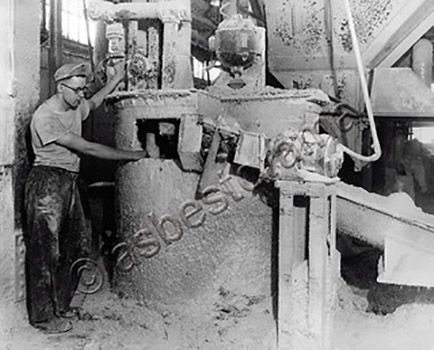 An asbestos dust-covered Johns-Manville worker