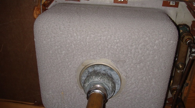 Bottom of a metal sink, covered in insulation made with asbestos