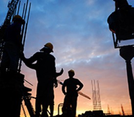 Construction workers at sunset Construction workers at sunset