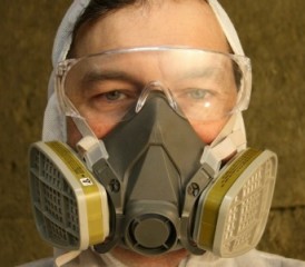 Man wearing goggles and a respirator mask Man wearing goggles and a respirator mask